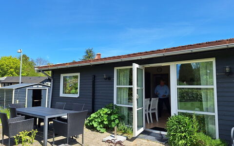 Arise - 1.5Km from the Sea: Tür, Zuhause, Haus, Möbel, Hütte, Abstellgleis, Veranda, Stuhl, Garten, Schatten
